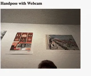 A video feed of a hand up in the air with green dots on each finger